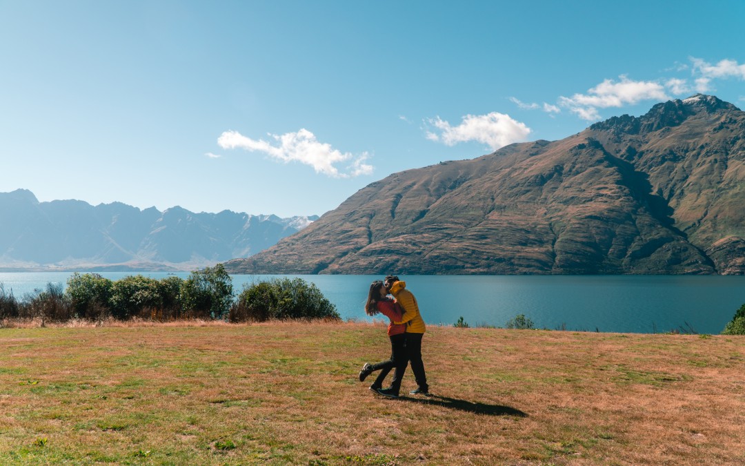 A couple embracing with beautiful Queenstown backdrop.