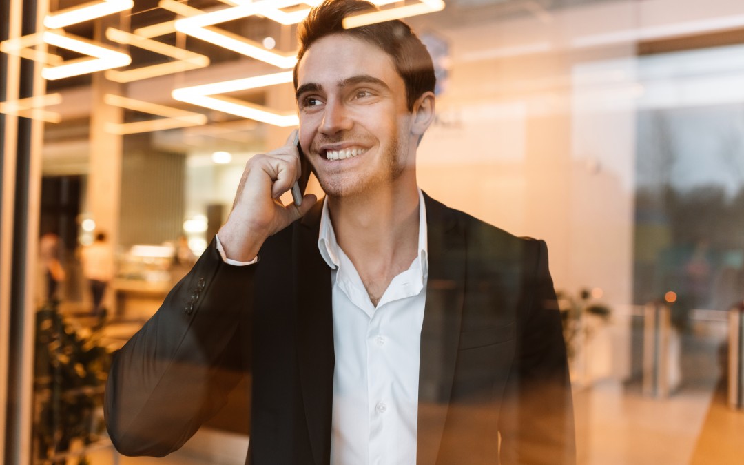 young businessman smiling whilst on the phone
